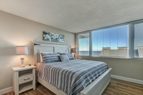 a bedroom with a bed and a large window at 1172 Beach Walker in Amelia Island