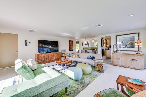 a living room with a couch and a tv at Luxury Coachella Rental Near Dtwn Palm Springs! in Palm Springs