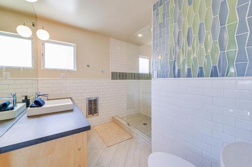 a bathroom with a sink and a bath tub at Luxe Palm Springs Home - Close to Downtown! in Palm Springs