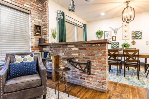 a living room with a brick fireplace at Pleasantly Plush - Quality and Comfort Downtown in Tulsa