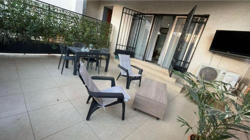 a patio with a table and chairs on a balcony at RESIDENCE ABBAS in Yaoundé