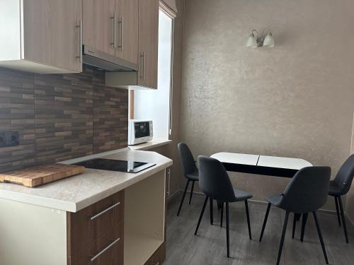 a kitchen with a table and chairs in a room at Centralnyi hotel in Poltava