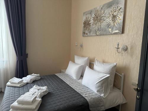 a bedroom with a bed with two towels on it at Centralnyi hotel in Poltava