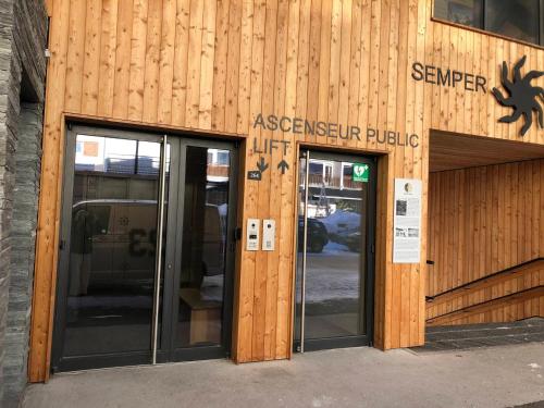 an entrance to the entrance to a javascriptrequired public building at Luxueux Appartement avec Spa et Jacuzzi au pied des pistes à Tignes - FR-1-641-1 in Tignes