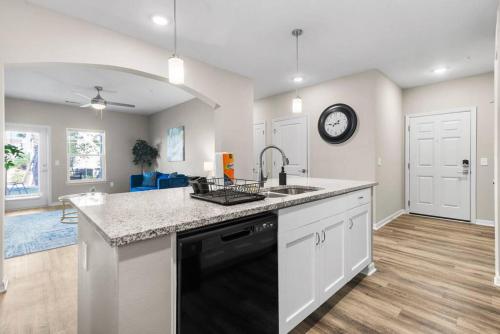 a kitchen with a sink and a clock on the wall at Contemporary Haven with Modern Amenities in Melbourne