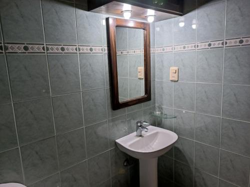 a bathroom with a sink and a mirror at Los Lirios de Dayman in Termas del Daymán