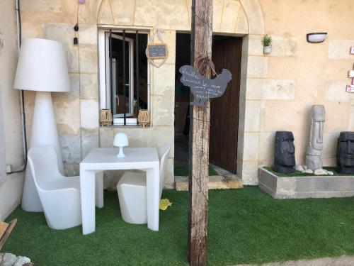 a house with a toilet and a table and a lamp at la cave in Montoire-sur-le-Loir