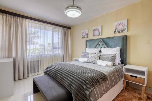 a bedroom with a large bed and a window at Lovely 2-bedroom apartment, with an amazing view in Durban