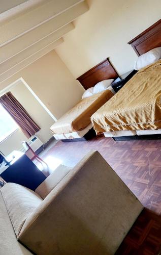 a room with three beds in a room at Metro Inn & Suites in Jacksonville