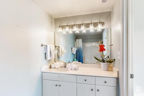 a bathroom with a sink and a mirror at Shores of Panama III in Panama City Beach