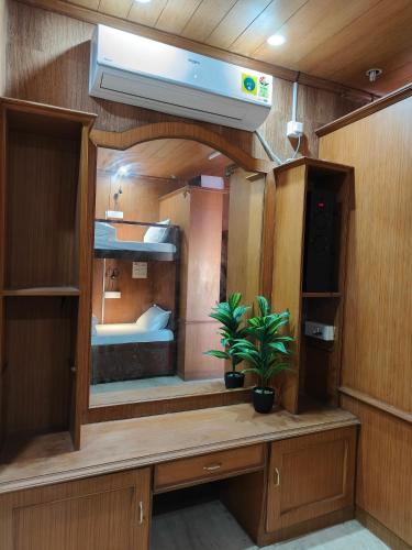 a room with a large mirror and a plant in it at Unpack Hostel in Puducherry