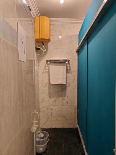 a bathroom with a shower with a glass door at Unpack Hostel in Puducherry
