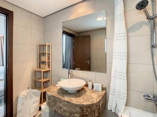 a bathroom with a sink and a large mirror at Key View - Hilliana Tower in Dubai