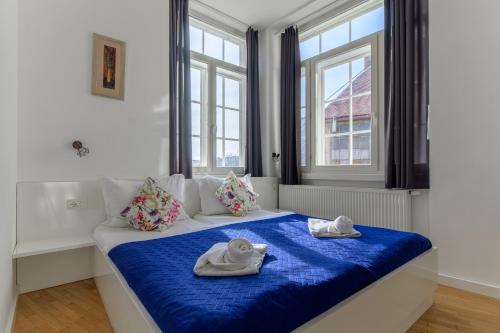 a bedroom with a bed with towels on it at Niva Rooms & Studio Apartment in Zagreb