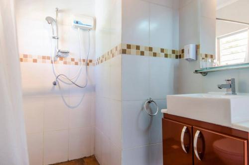 a bathroom with a shower and a sink at Studios with beautiful sea view in Willemstad