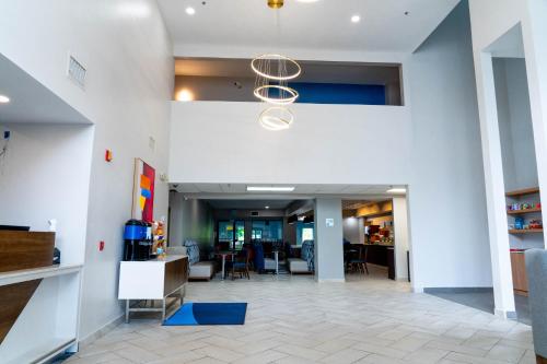 an office lobby with a hallway with chairs and a chandelier at Holiday Inn Express Hotel & Suites Hiawassee, an IHG Hotel in Hiawassee