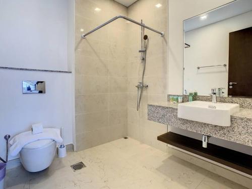 a bathroom with a sink and a shower and a toilet at Key View - Villa, Casa Flores in Dubai