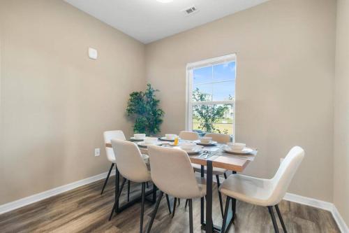a dining room with a table and chairs and a window at Chic 2 BD/2 BA Condo: Serene Escape in Melbourne in Melbourne