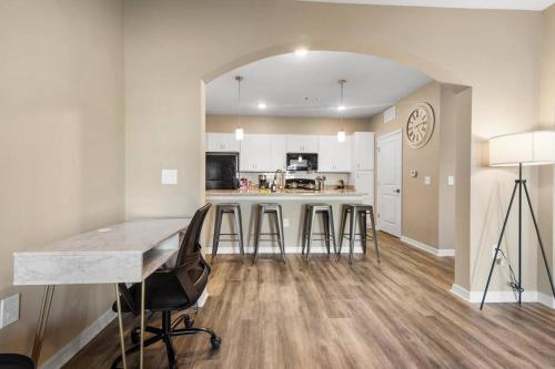 a kitchen with a table and chairs in a room at Chic 2 BD/2 BA Condo: Serene Escape in Melbourne in Melbourne
