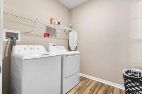 a laundry room with a washer and dryer at Chic 2 BD/2 BA Condo: Serene Escape in Melbourne in Melbourne