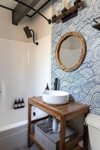 a bathroom with a sink and a mirror on a wall at Knotty Bear Haus in Big Bear City