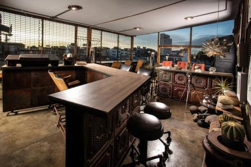 a room with a bar with a view of a city at La Cangreja Casa Biosferista in Bogotá