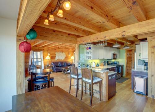 a kitchen and living room with a table and chairs at Hot Tub and Game Room Powderhorn Mountain Cabin in Powderhorn Mountain