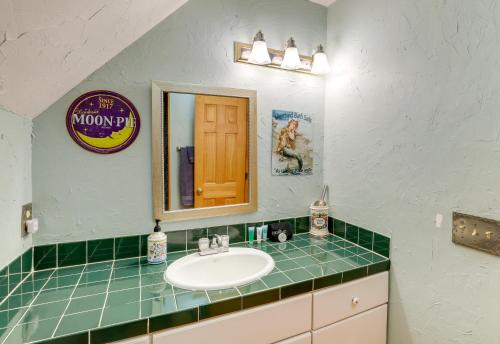 a bathroom with a sink and a mirror at Hot Tub and Game Room Powderhorn Mountain Cabin in Powderhorn Mountain