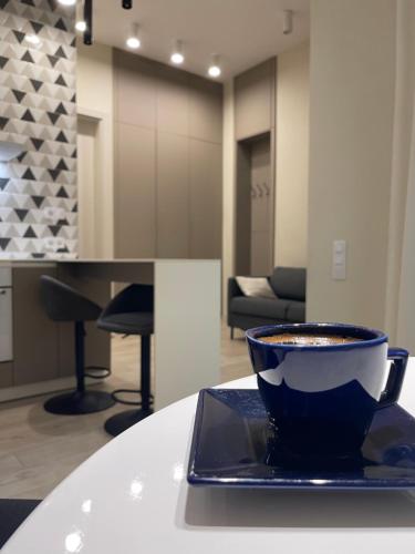 a cup of coffee sitting on a plate on a table at SCANDIC-LUX apartments-feels like home! В центрі Львова in Lviv