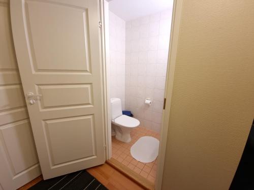 a bathroom with a white toilet and a door at Hiihtäjänkuja 5A4, Levi in Levi