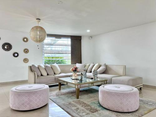 a living room with a couch and a table at HELENE HOUSE in Sincelejo