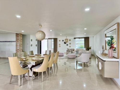 a dining room and living room with a table and chairs at HELENE HOUSE in Sincelejo