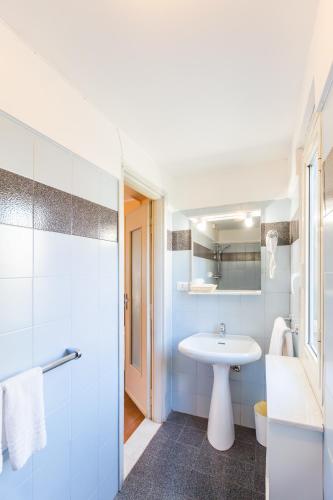 a bathroom with a white sink and a shower at Hotel Castello in Turin