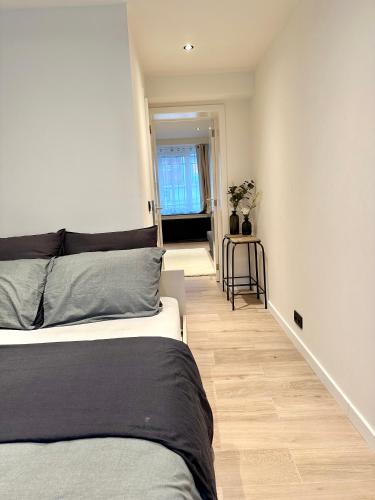 a bedroom with two beds and a hallway at My Haus European Commision in Brussels