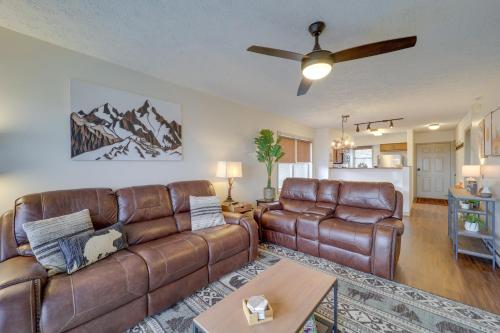 a living room with leather furniture and a ceiling fan at Lovely Beech Mountain Condo with Balcony and Views! in Beech Mountain
