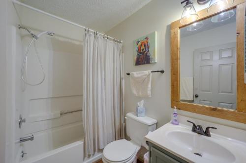 a bathroom with a sink and a toilet and a mirror at Lovely Beech Mountain Condo with Balcony and Views! in Beech Mountain
