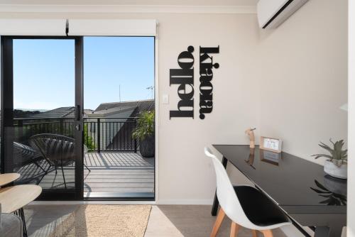 a dining room with a table and chairs at Luxury Apartment retreat in Tauranga