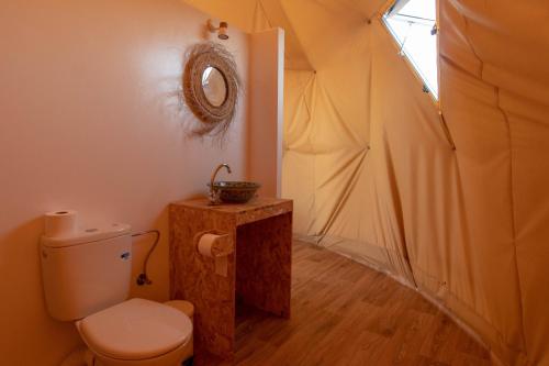 a bathroom with a toilet in a tent at Timlalin Dome in Tamri