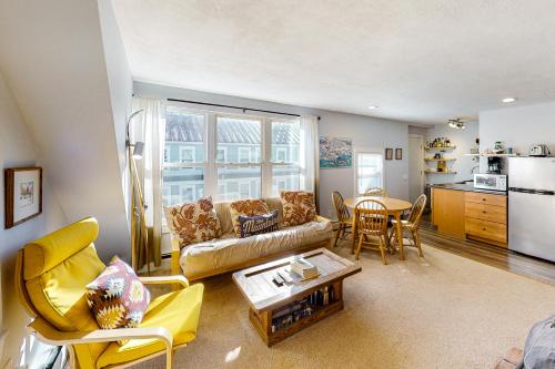 a living room with a couch and a table at Depot Street Condo in Proctorsville