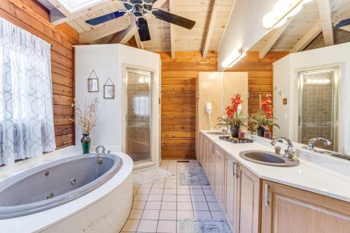 a bathroom with two sinks and a large tub at Peaceful Lawrenceville Cabin with Hot Tub on 6 Acres in Lawrenceville