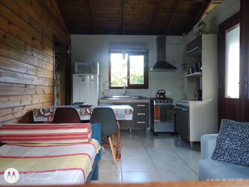 cocina con mesa y sillas en una habitación en Bangalô Kontiki, en Florianópolis