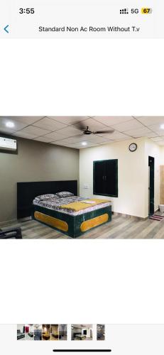 a room with a bed in the middle of it at Vickys Guest House in Malvan