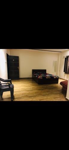 a bedroom with a bed in the corner of a room at Vickys Guest House in Malvan