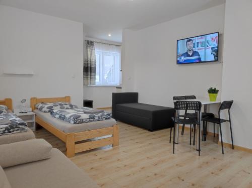 a living room with a bed and a table and chairs at Górski Kryształ in Stronie Śląskie