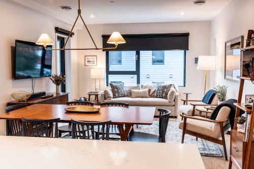 a living room with a table and a couch at Powder Pines Retreat by Revelstoke Vacations in Revelstoke