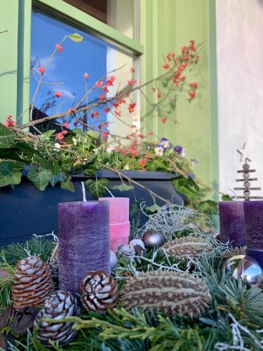 a display of christmas decorations in front of a window at Pannonhalma Várlak Vendégház in Pannonhalma
