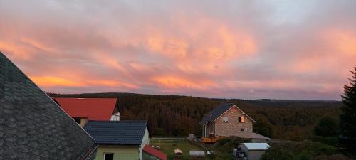 a cloudy sky over a village with houses and trees at Ferienwohnung M.Spindler in Frauenwald