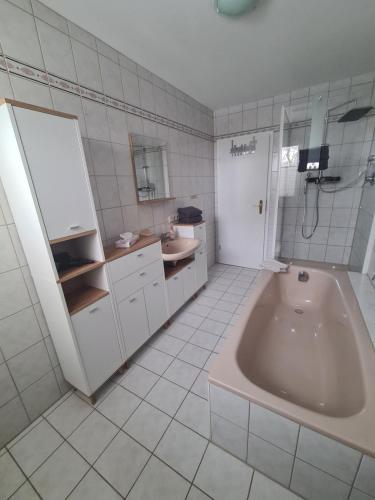 a bathroom with a large tub and a sink at Monteurwohnung in Bad Neustadt an der Saale