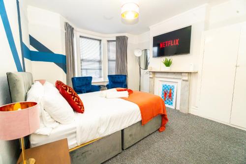 a bedroom with a bed and a fireplace at Bright Medway studio flat opposite Chatham station in Chatham