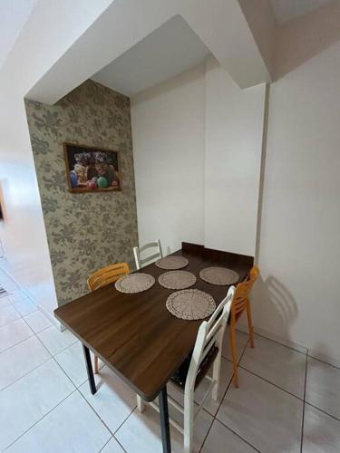 a wooden table and chairs in a room at Apto Aconchegante Central! 23 in Toledo